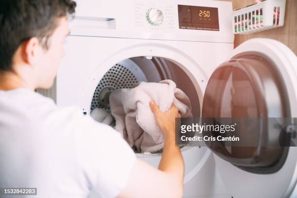 man using dryer - secador de roupas imagens e fotografias de stock