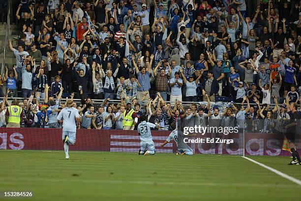 Graham Zusi of the Sporting Kansas City celebrates his goal with Kei Kamara of the Sporting Kansas City and fans during a game against the Chicago...