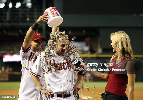 Aaron Hill of the Arizona Diamondbacks is covered in bubble gum by Gerardo Parra as he receives his post game interview from television personality...