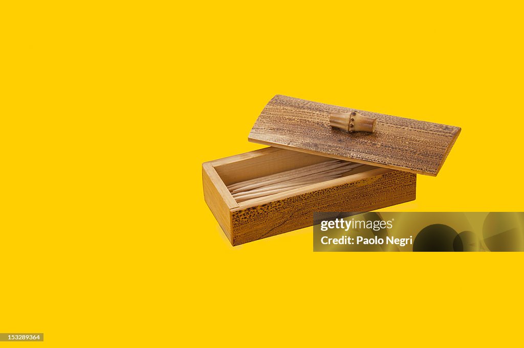 Bamboo toothpick box on yellow background