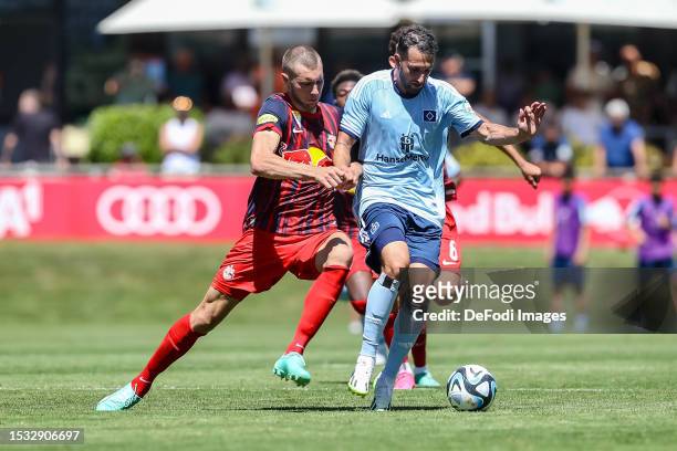 Strahinja Pavlovic of Red Bull Salzburg and Levin Oeztunali of Hamburger SV battle for the ball during the pre-season friendly match between RB...
