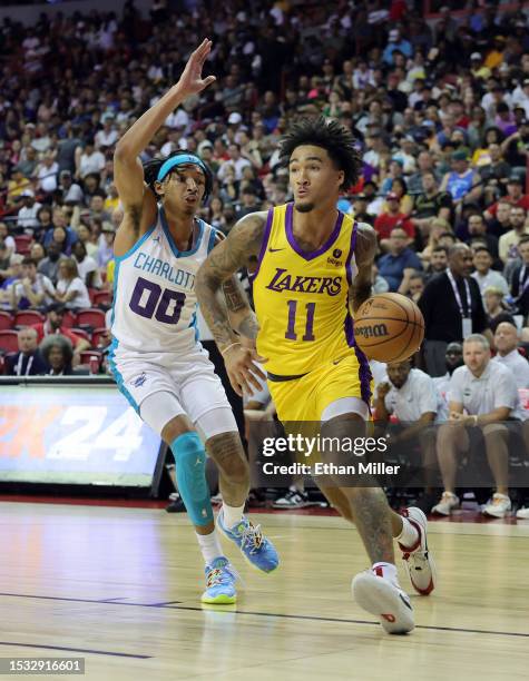 Jalen Hood-Schifino of the Los Angeles Lakers drives against Nick Smith Jr. #00 of the Charlotte Hornets in the second half of a 2023 NBA Summer...