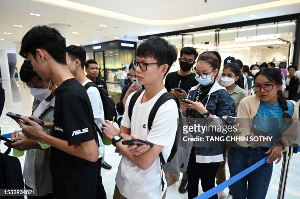 People line up to attend the first Apple Premium Reseller grand opening in Phnom Penh on July 15, 2023