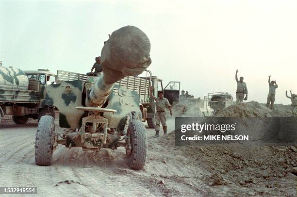 Iraqi soldiers wave near a tank after the destruction of Iranian positions in the strategic Faw peninsula of Southeast Iraq during Iran-Iraq war, on...