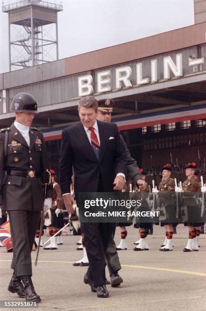 President Ronald Reagan, commemorating the 750th anniversary of Berlin, reviews honor guard of Royal Regiment of Scotland on June 12, 1987 after his...