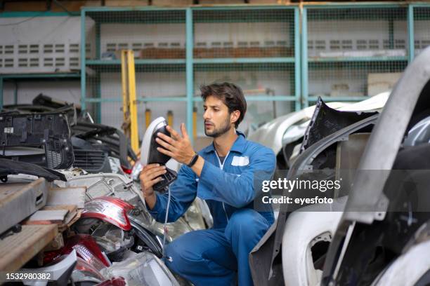 young entrepreneur work at car garage. - man bumper car stock pictures, royalty-free photos & images