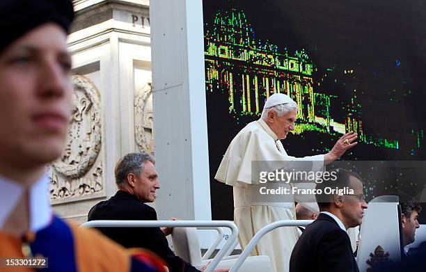 Pope Benedict XVI, flanked by his personal secretary Georg Ganswein arrives on the popemobile in St. Peter's square for his weekly audience on...
