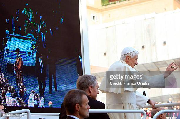 Pope Benedict XVI, flanked by his personal secretary Georg Ganswein arrives on the popemobile in St. Peter's square for his weekly audience on...