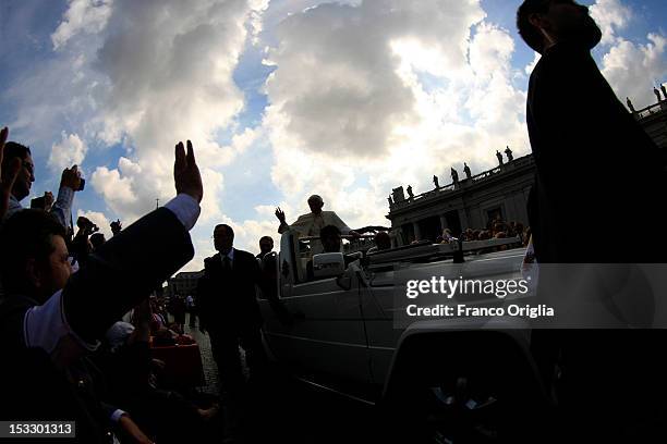 Pope Benedict XVI arrives on the popemobile in St. Peter's square for his weekly audience on October 3, 2012 in Vatican City, Vatican. The trial of...