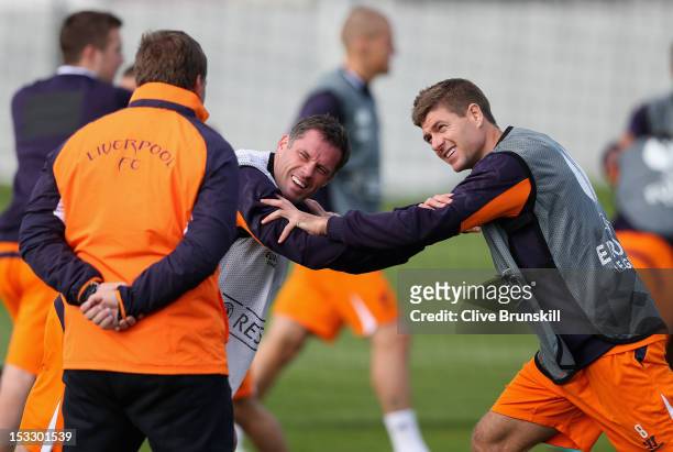 Liverpool manager Brendan Rodgers shares a joke with Jamie Carragher and team captain Steven Gerrard during a training session ahead of their UEFA...