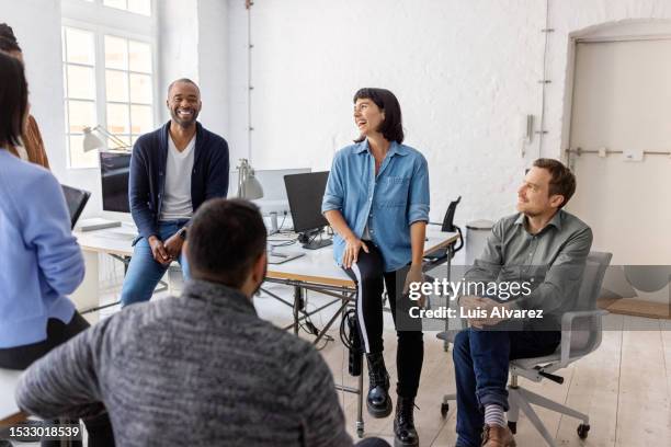 multiracial businesspeople having a casual conversation at the office after meeting - company culture stock pictures, royalty-free photos & images