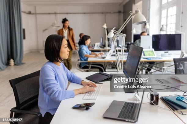 programmer writing code for computer programs and mobile applications - programmer working stock pictures, royalty-free photos & images