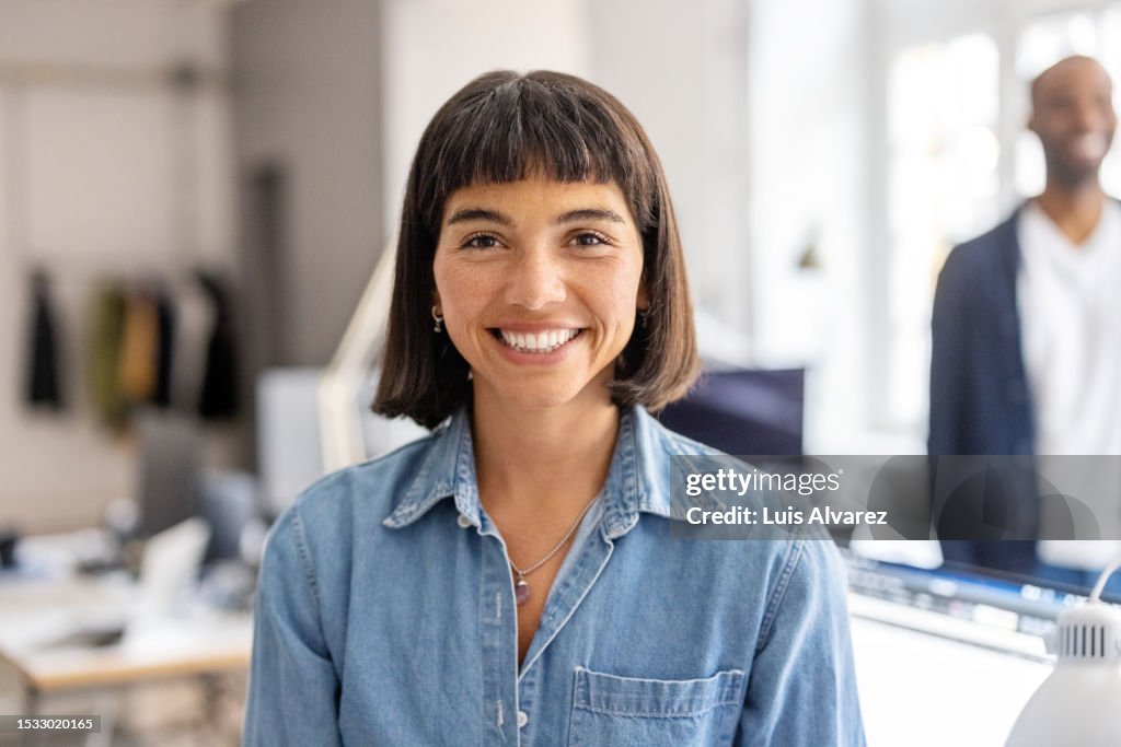 Portrait of confident hispanic woman standing in office