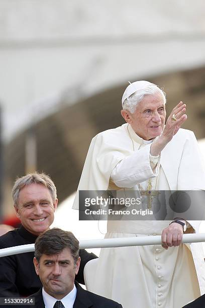 Pope Benedict XVI flanked by his personal secretary Georg Ganswein and his new butler Sandro Mariotti arrives on popemobile in St. Peter's square for...