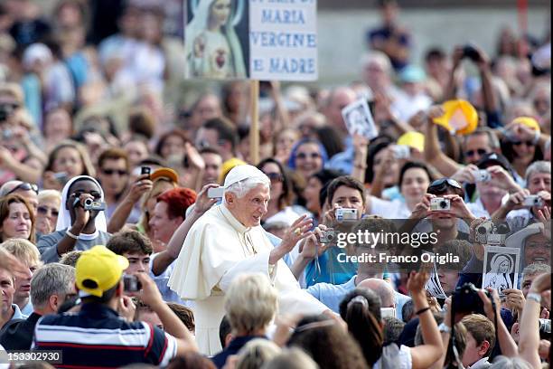 Pope Benedict XVI waves to the faithful gathered in St. Peter's square during his weekly audience on October 3, 2012 in Vatican City, Vatican. The...