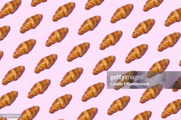 butter croissants pattern with hard shadow on pink background. industrial pastry concept, calories, fattening, fat, cholesterol, delicious, sugar - lunch and learn stock pictures, royalty-free photos & images