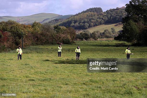 Police search in fields close to where Mark Bridger was arrested on October 3, 2012 near Machynlleth, Wales. Five-year-old April Jones was abducted...