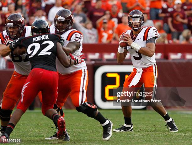 Quarterback Logan Thomas of the Virginia Tech Hokies looks to pass against the Cincinnati Bearcats during their NCAA football game at FedExField on...