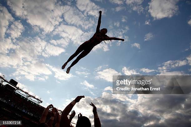 Members of the Virginia Tech Hokies cheerleading squad perform aerial stunts during their NCAA football game against the Cincinnati Bearcats at...
