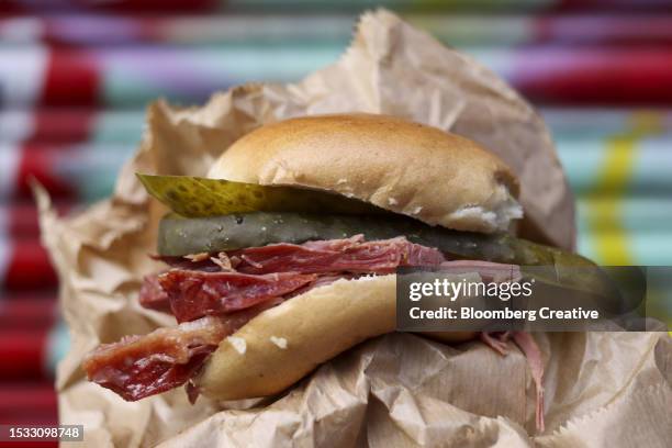 a salt beef bagel - pickle slices stock pictures, royalty-free photos & images