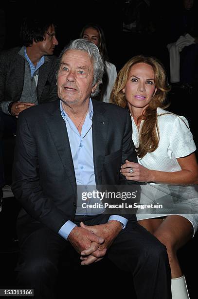 Alain Delon and Rosalie van Breemen attend the Elie Saab Spring/Summer 2013 show as part of Paris Fashion Week at Espace Ephemere Tuileries on...