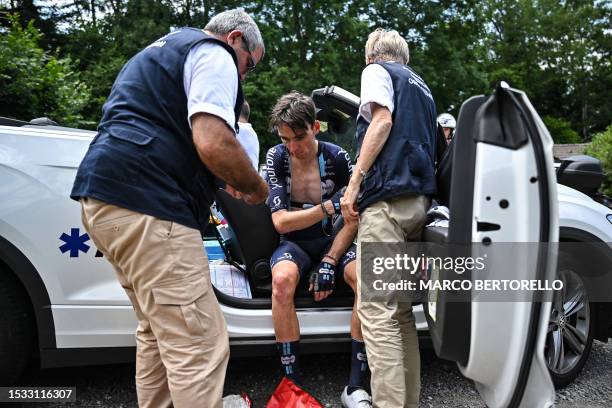 Team DSM - Firmenich's French rider Romain Bardet receives medical attention after a crash during the 14th stage of the 110th edition of the Tour de...