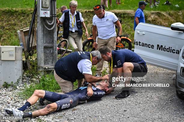 Team DSM - Firmenich's French rider Romain Bardet receives medical attention after a crash during the 14th stage of the 110th edition of the Tour de...