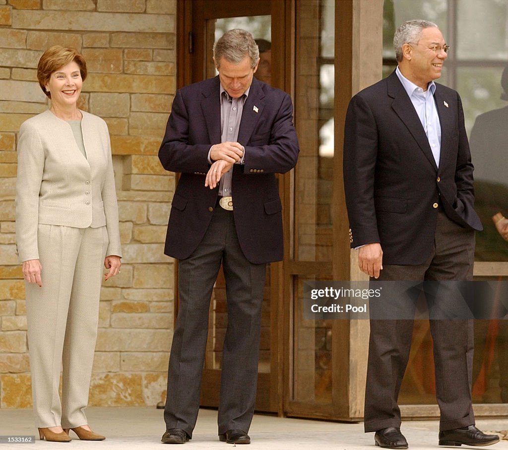 Colin Bush U.S. President George W. Bush checks his watch as his wife, first ...