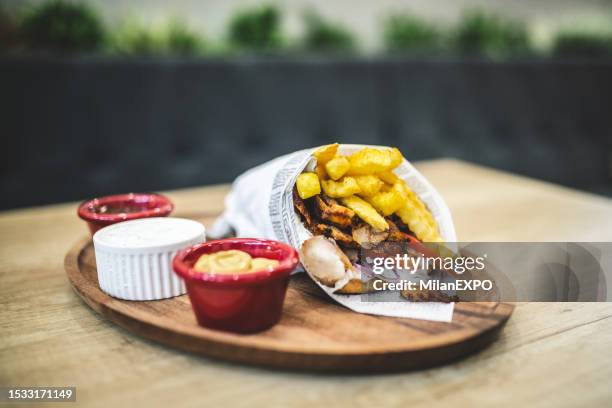 greek gyros wraped in a pita bread - souvlaki stock pictures, royalty-free photos & images