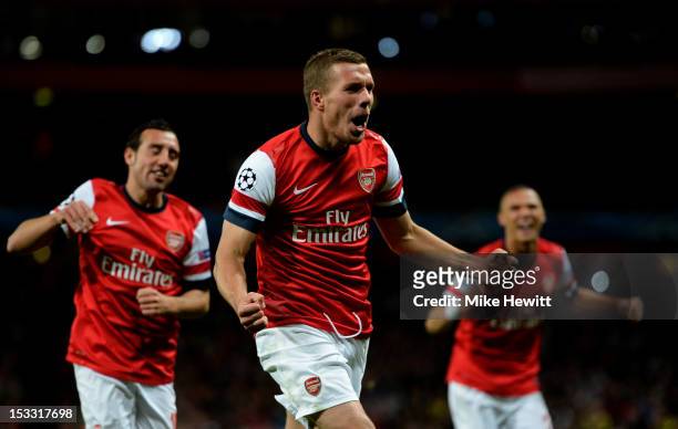 Lukas Podolski of Arsenal celebrates after scoring his team's second goal during the UEFA Champions League Group B match between Arsenal FC and...