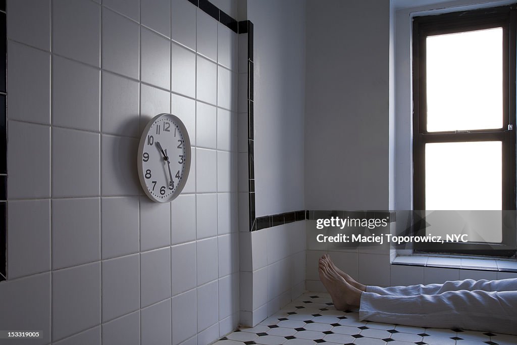 Man sitting in front of clock