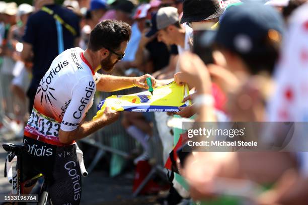 Simon Geschke of Germany and Team Cofidis signing autographs prior to the stage ten of the 110th Tour de France 2023 a 167.2km stage from Vulcania to...