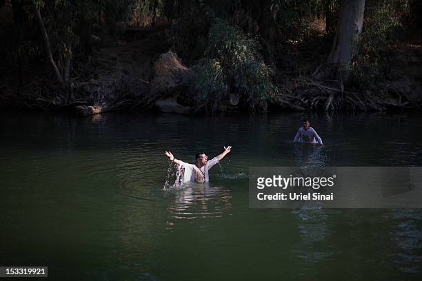 Christian pilgrim baptizes himself in the waters of the Jordan River on October 3, 2012 at Yardenit in northern Israel. An estimated 100,000...