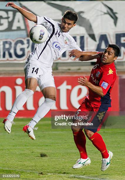 Alibobo Rakhmatullaev of Bunyodkor and Cassio Oliveira of Adelaide compete for the ball during the AFC Champions League quarter-final second leg...