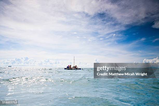 sailing on a makeshift handmade raft. - makeshift raft stock pictures, royalty-free photos & images