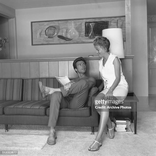 American actor Clint Eastwood with his first wife Maggie Johnson at their home in the Hollywood Hills, Los Angeles, California, circa 1960.