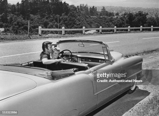 American actor Clint Eastwood with his first wife Maggie Johnson in a Cadillac convertible, USA, circa 1960.