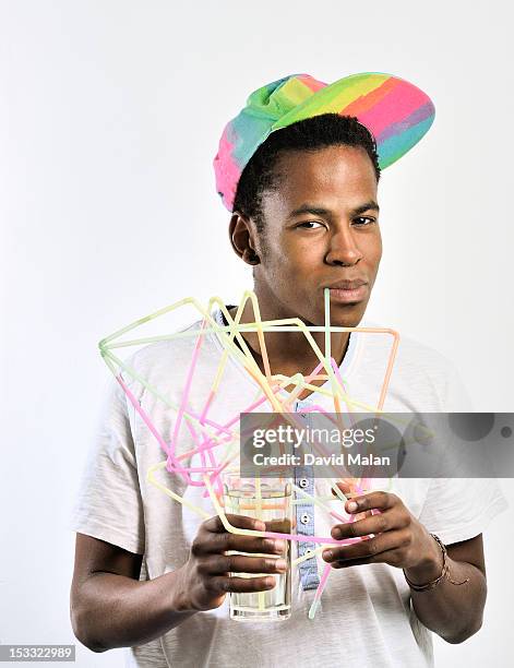 young man drinking through connected straws - david swallow stock pictures, royalty-free photos & images