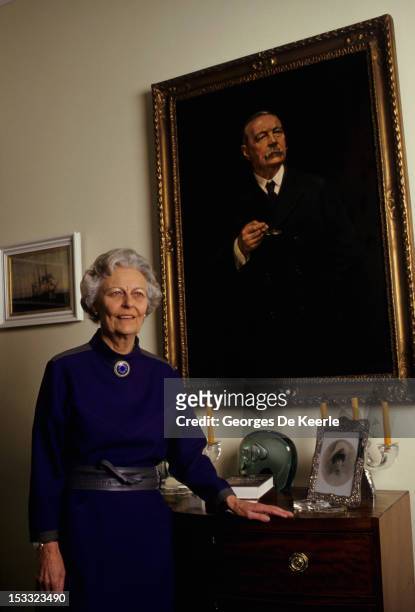 Dame Jean Conan Doyle, daughter of Sir Arthur Conan Doyle, poses in front of a portrait of her father, the writer who created the fictional detective...