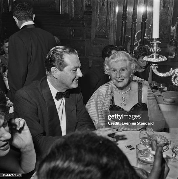 British dramatist and screenwriter Terrence Rattigan and mother Vera attending an event, February 25th 1959.