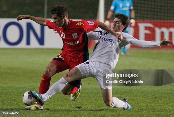 Javlon Ibrokhimov of Bunyodkor and Dario Vidosic of Adelaide fight for the ball during the AFC Champions League Quarter Final match between FC...