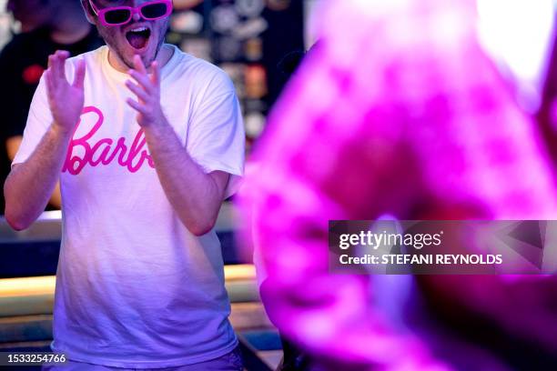 Attendee Jack Brunson wears a Barbie shirt while watching drag performer Rosie Beret dance during the "Barbie's World!" drag show at Red Bear Brewing...