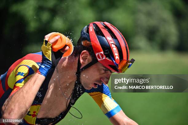 Lidl - Trek's Italian rider Giulio Ciccone douses himself with water to cool down as he cycles in a breakaway during the 14th stage of the 110th...