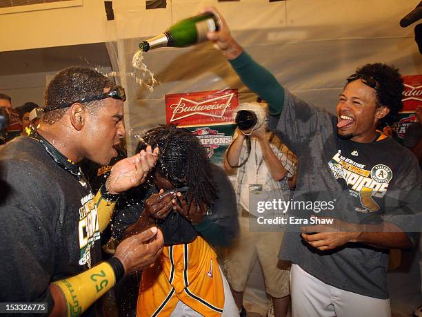 Yoenis Cespedes and Coco Crisp of the Oakland Athletics celebrate in the lockerroom after they beat the Texas Rangers at O.co Coliseum on October 3,...