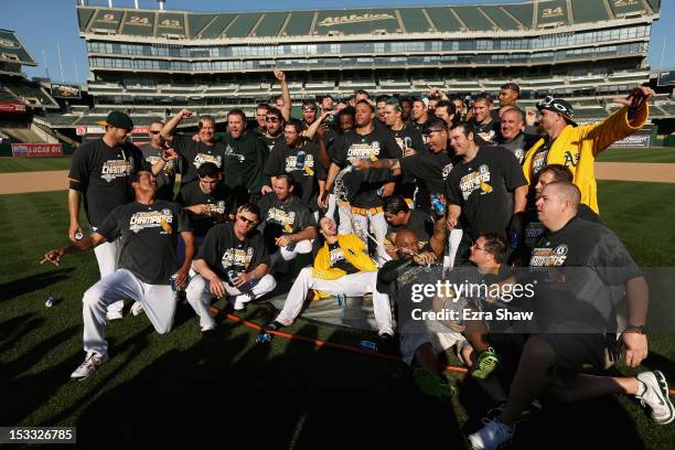 The Oakland Athletics pose for a team photo after they beat the Texas Rangers to win the American League West Division title at O.co Coliseum on...