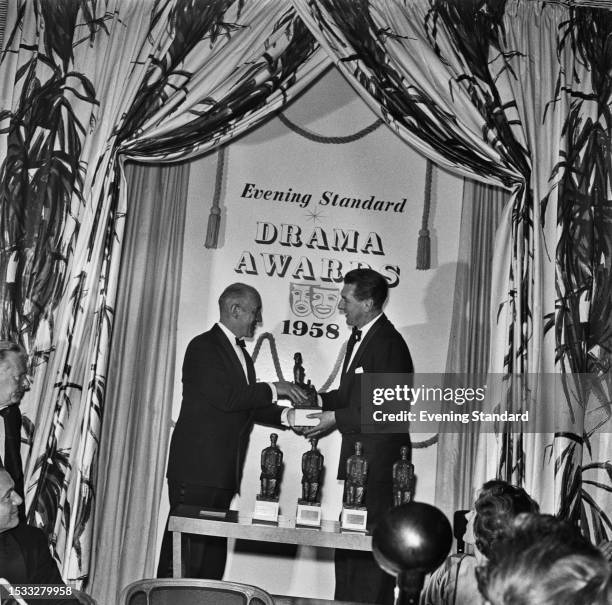 British actor Alec Guinness presenting the Best Actor award to Michael Redgrave at the Evening Standard Drama Awards for 1958, London, January 27th...