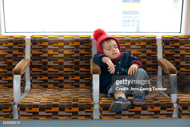 toddler asleep on public transport - baby gate imagens e fotografias de stock