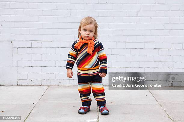 a small boy posing in front of brick wall - striped scarf stock pictures, royalty-free photos & images