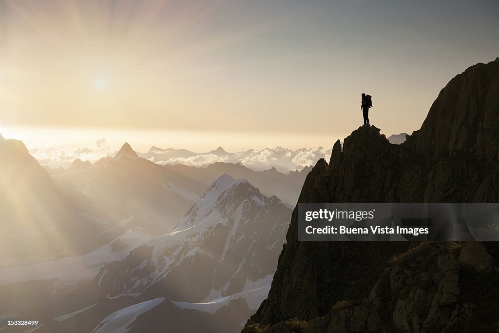 Lone climber on top of a peak