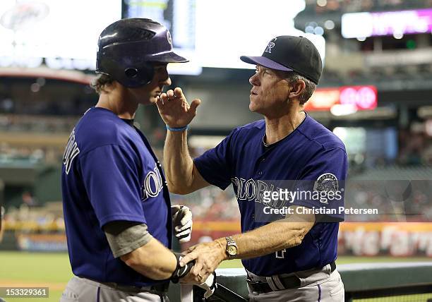 Manager Jim Tracy of the Colorado Rockies congratulates Charlie Blackmon after he scored a fourth inning run against the Arizona Diamondbacks during...